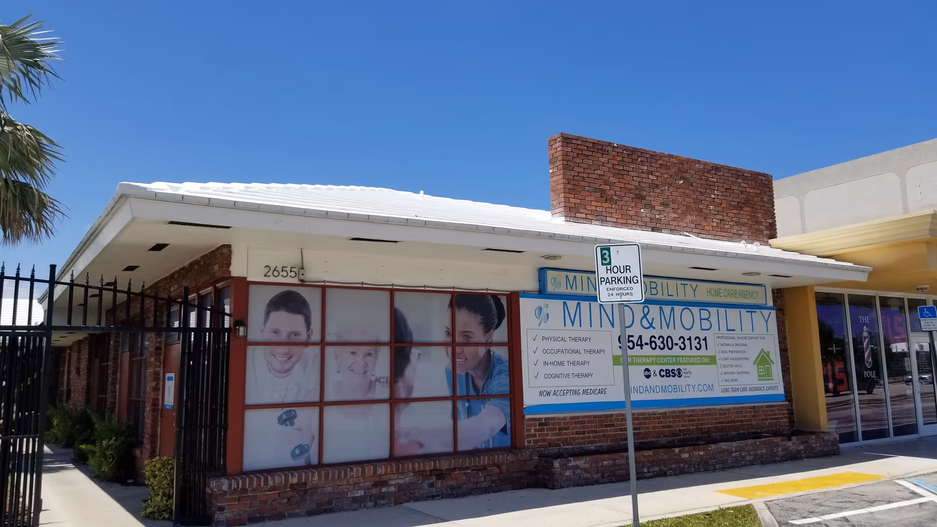 Brick, single-story building with large windows and Mind & Mobility signage on the front.