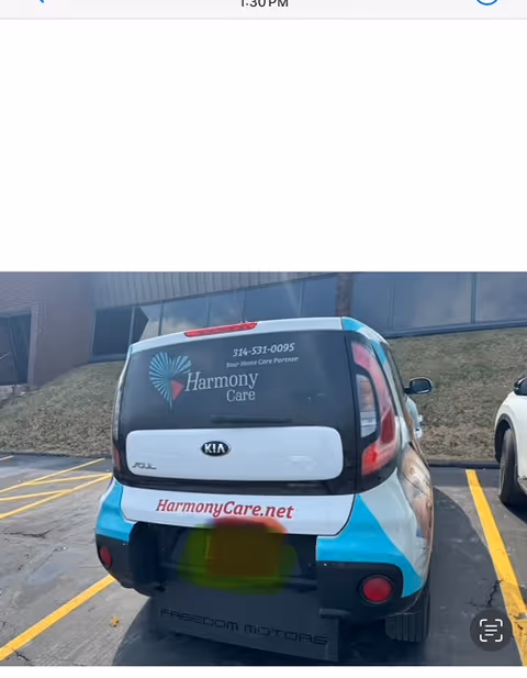 Rear view of a Harmony Care vehicle parked outside a facility.
