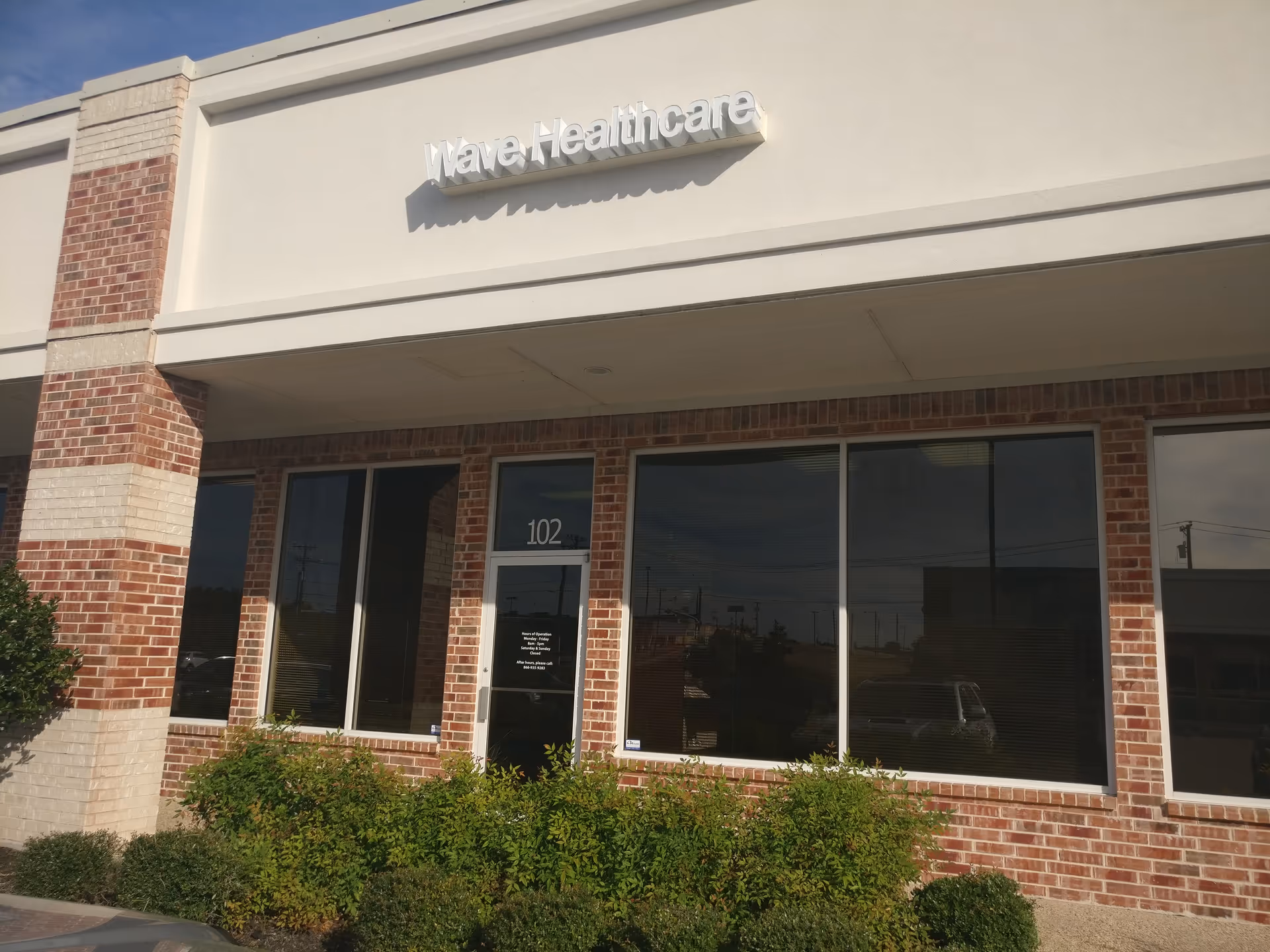 Facade of Wave Healthcare Temple building with brick exterior and large front windows.