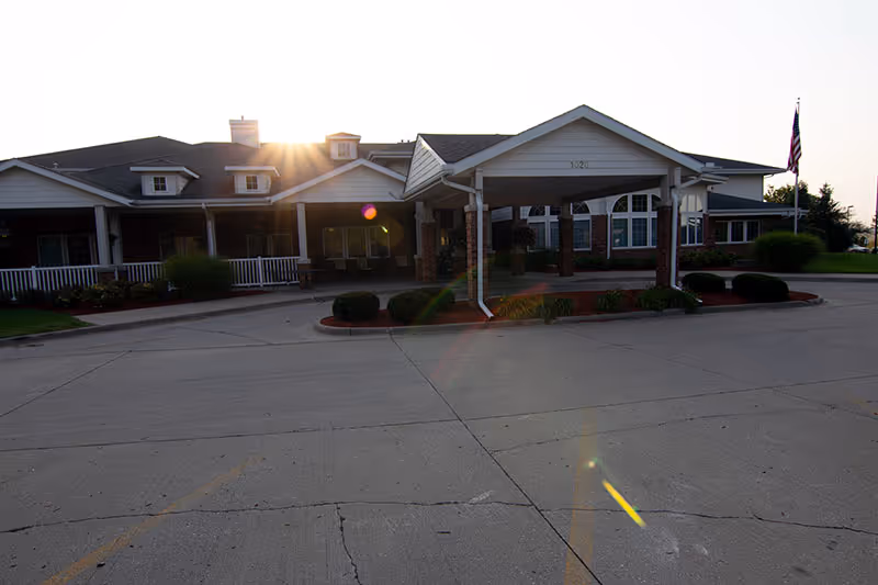 Front view of a single-story senior living facility with a covered entrance.