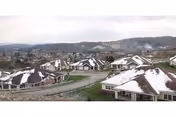Exteriors of Serra Mesa Guests Home cottages on a hillside with snowy rooftops.