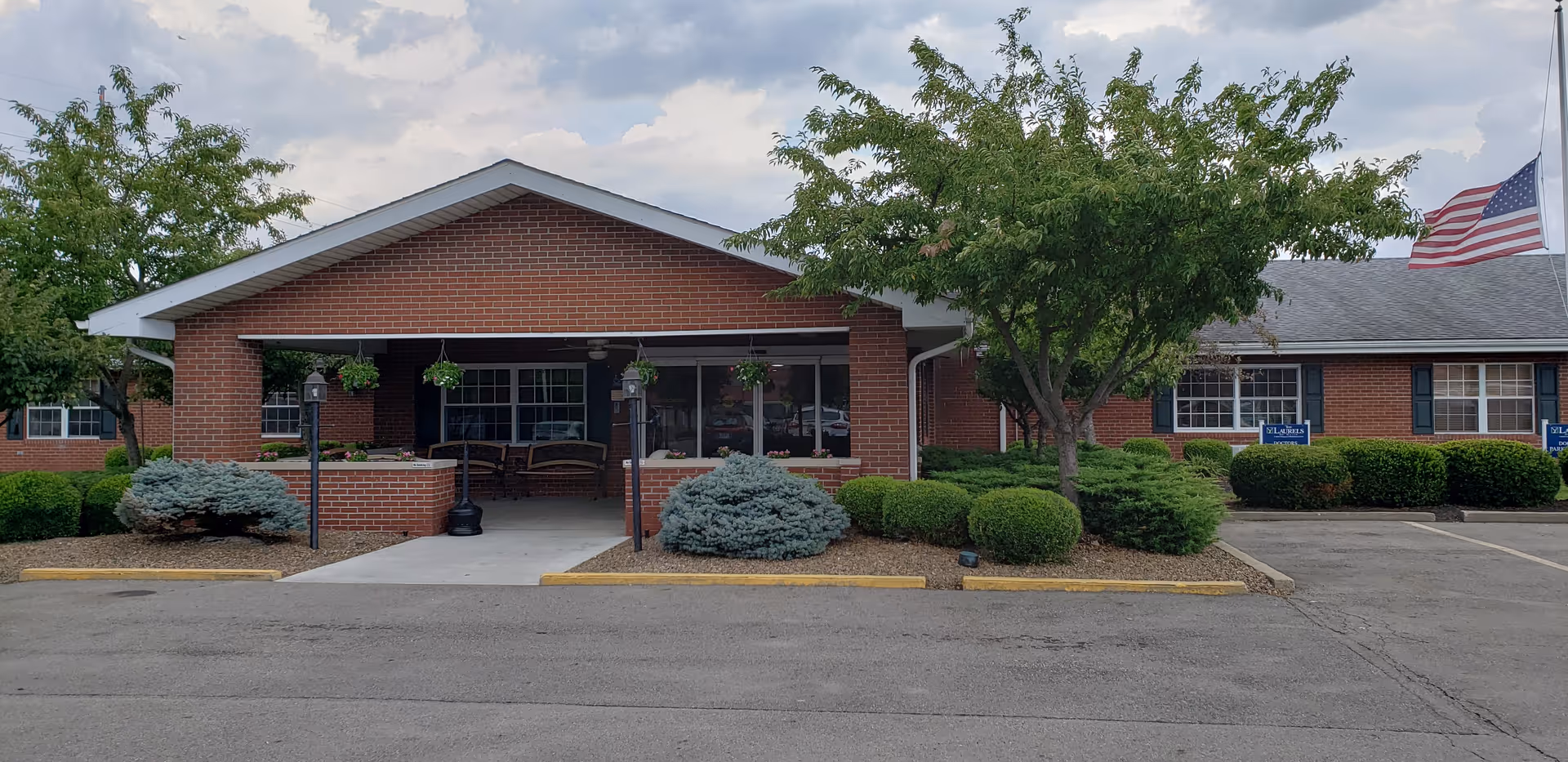 Exterior view of The Laurels of Heath, brick building with covered entrance.