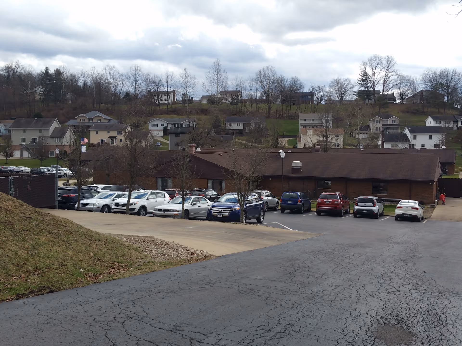 Bridgeport Healthcare Center exterior: single-story brick building with brown roof and a busy parking lot.