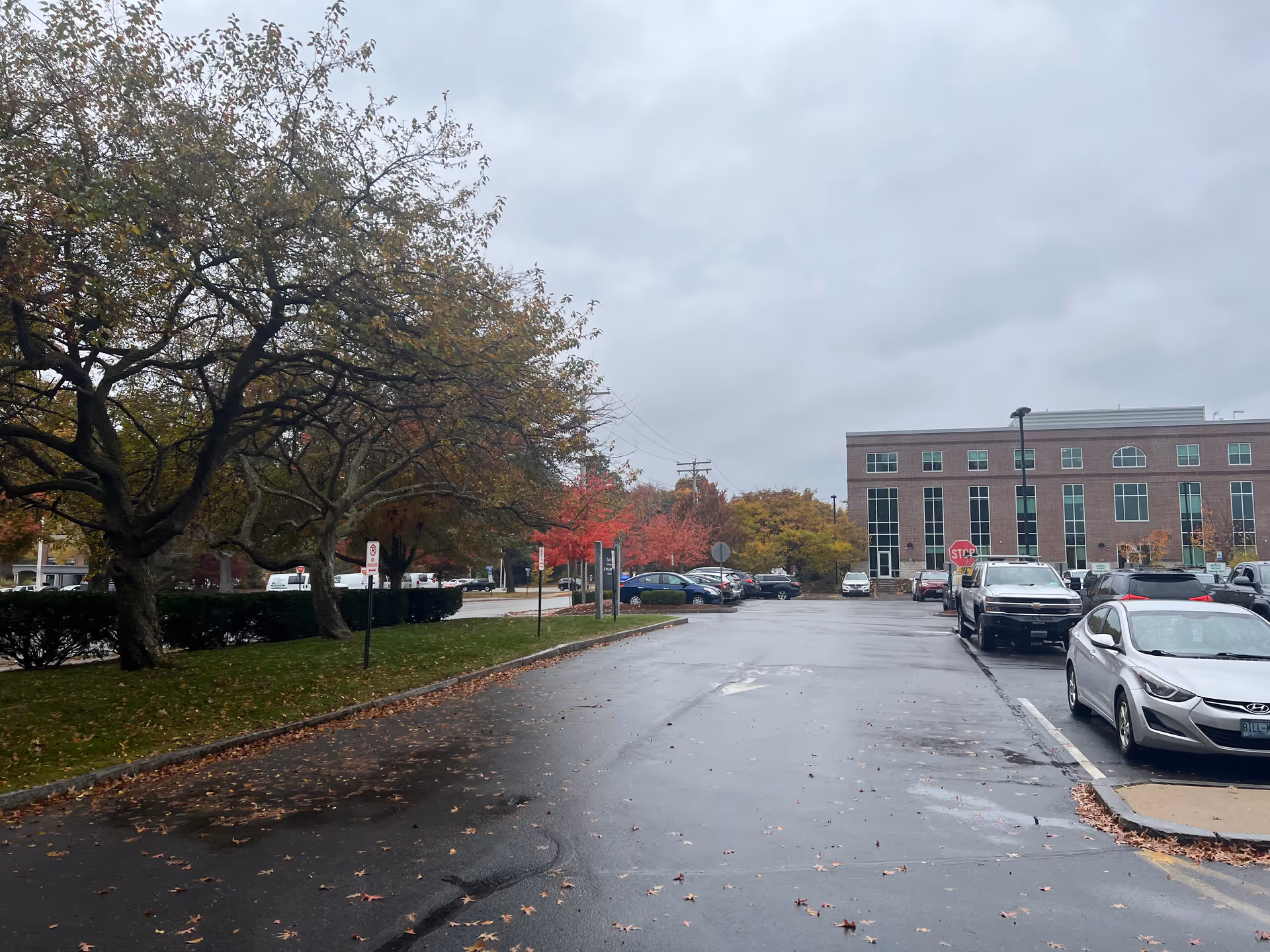 Overcast parking lot view of Granite VNA building facade with trees.