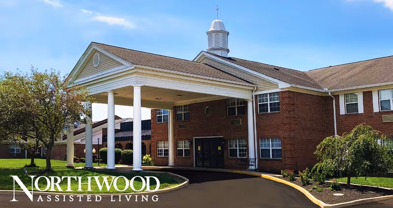 Exterior view of Northwood Assisted Living entrance with a portico.