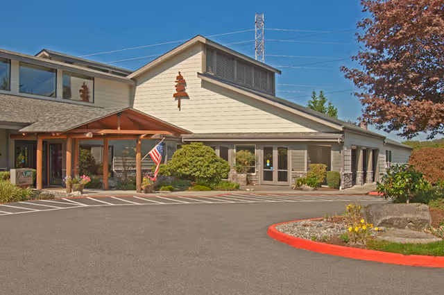 Exterior view of GenCare Lifestyle, Inc. facility with entrance, parking, and manicured landscaping.