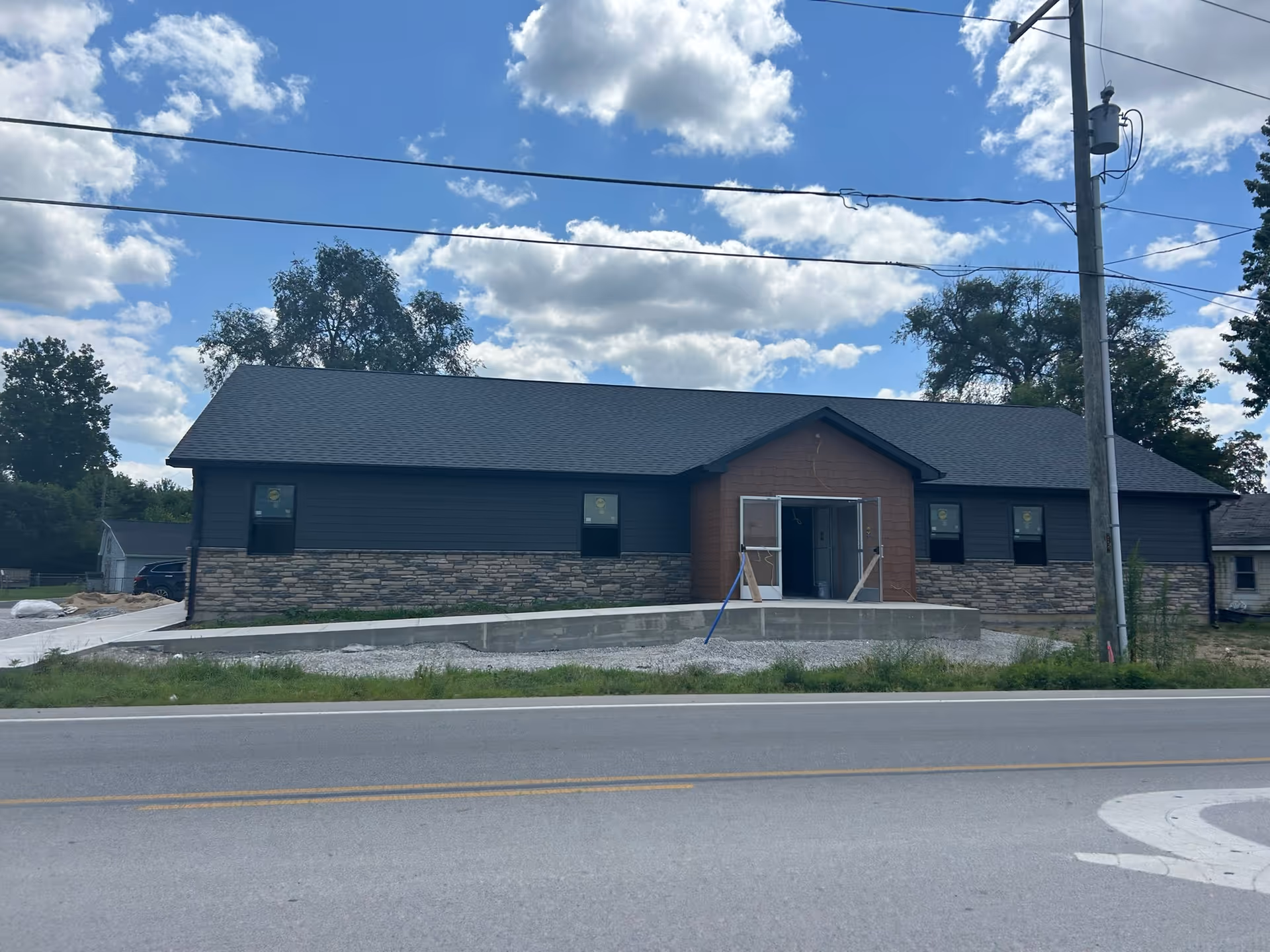Single-story building exterior with brick accents and a central accessible entrance.