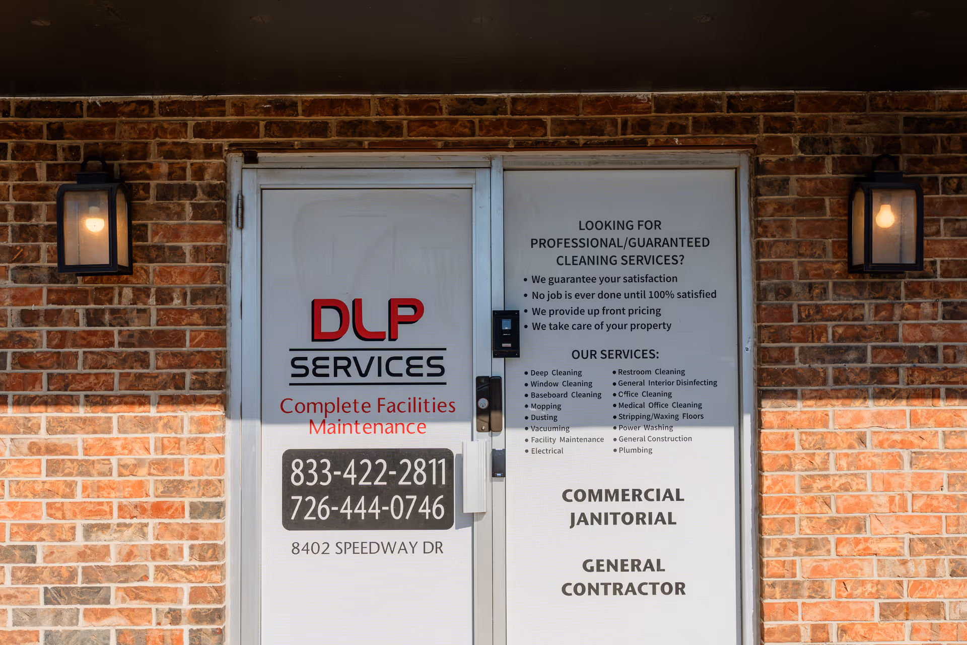 Brick building front with glass door and DLP SERVICES sign.