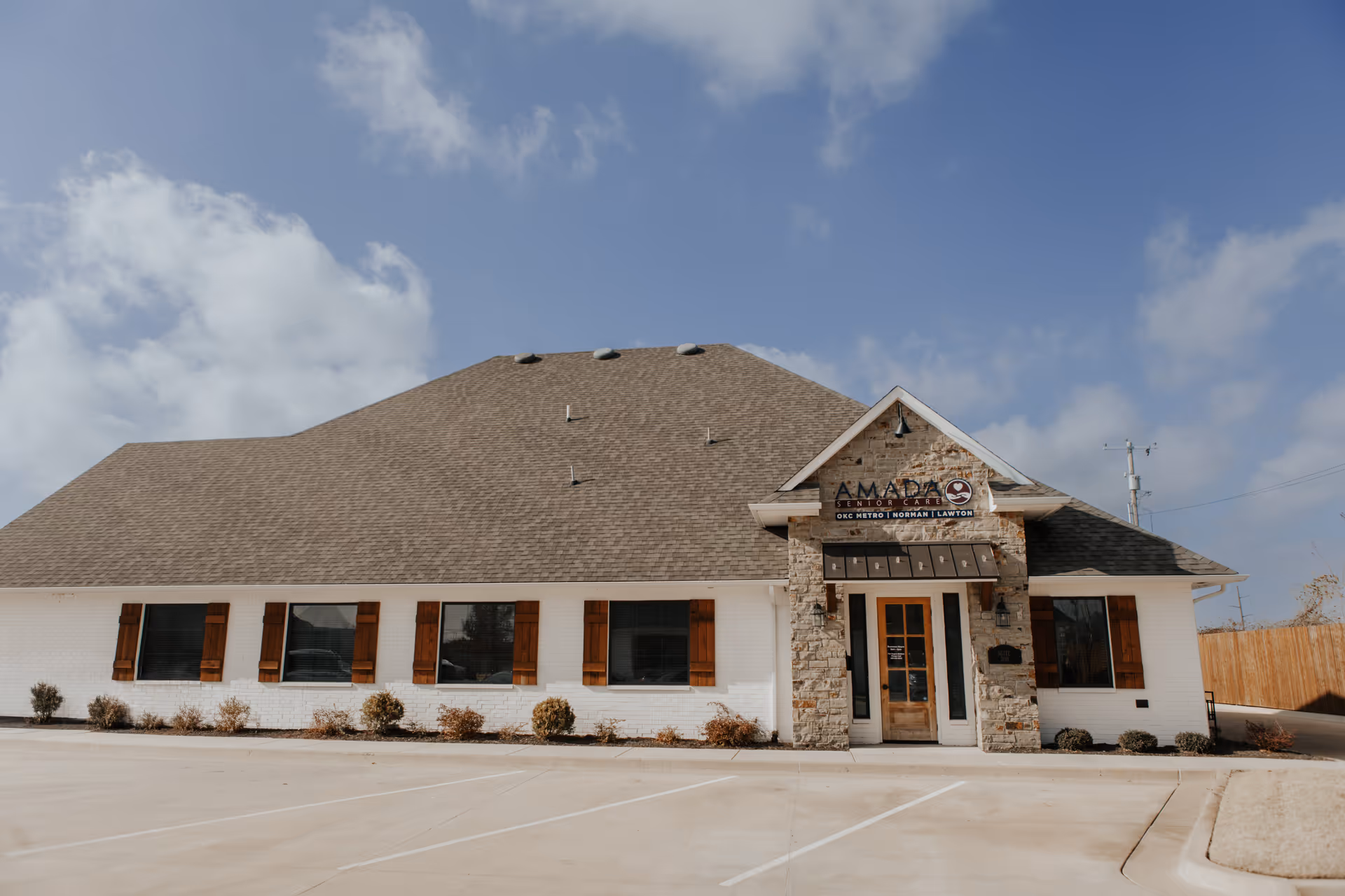 Amada Senior Care building front with stone entrance and surrounding parking.