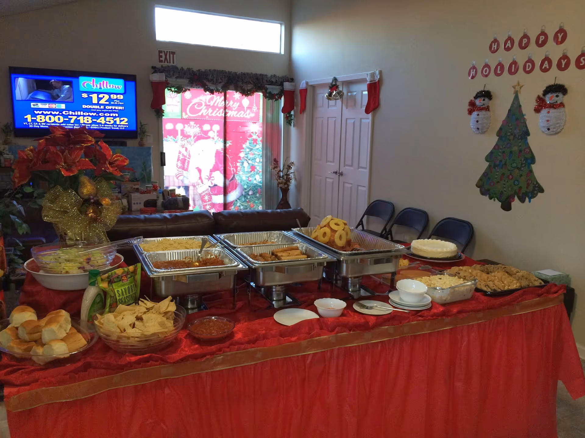 Holiday-decorated dining room with a large buffet and serving dishes.