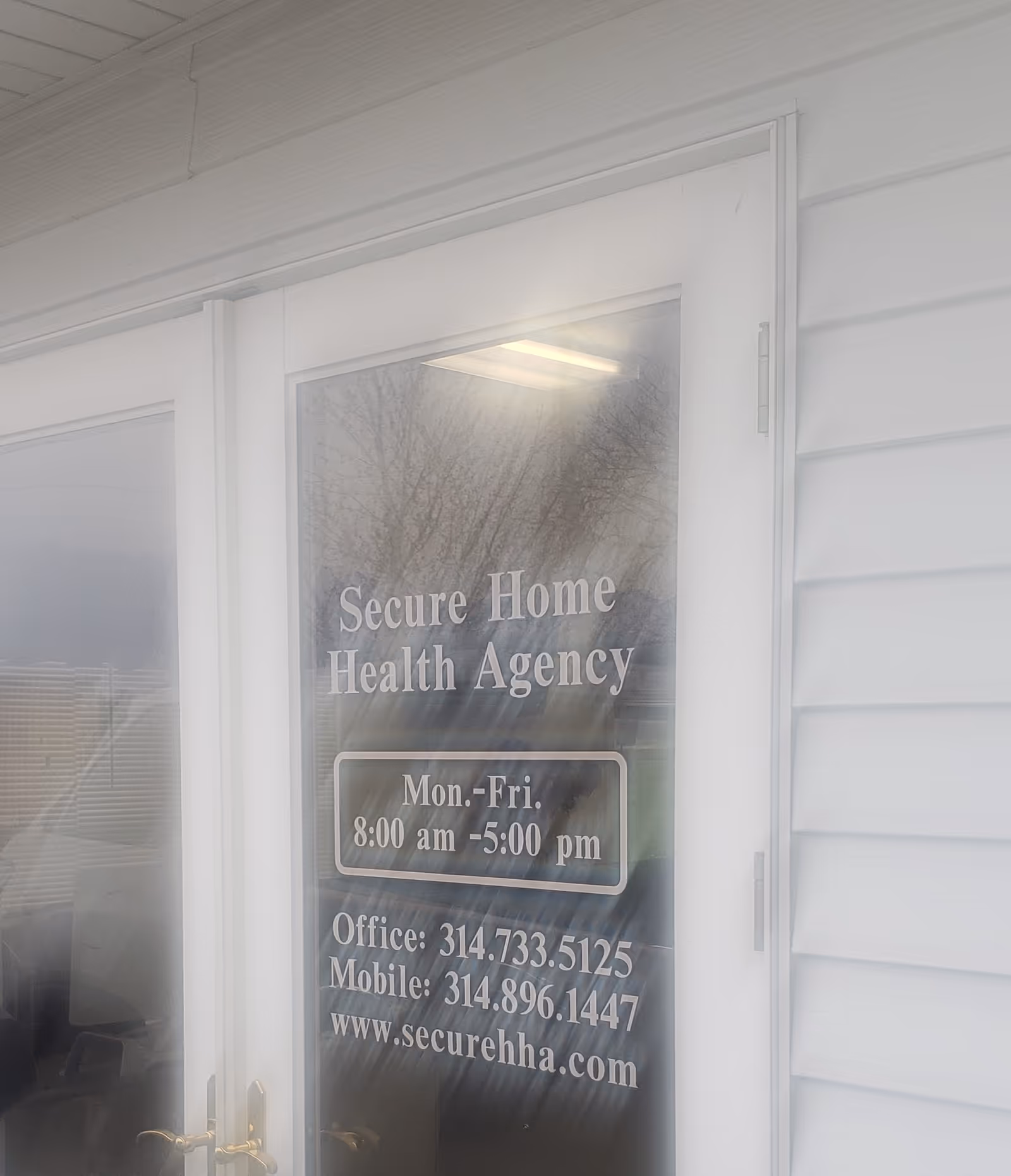 Glass door displaying Secure Home Health Agency name and office hours.