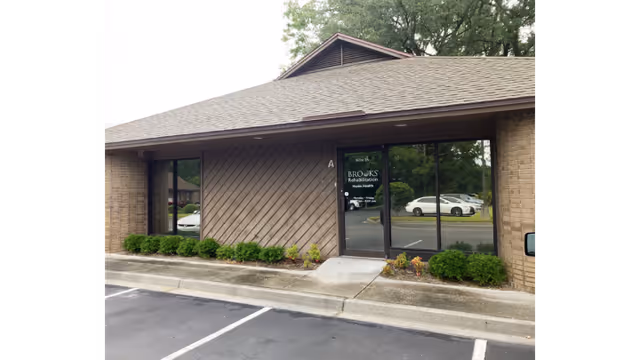 Front view of Brooks Rehabilitation Home Health building with glass doors.