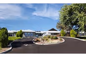 Single-story senior living facility with circular driveway and landscaped center island.