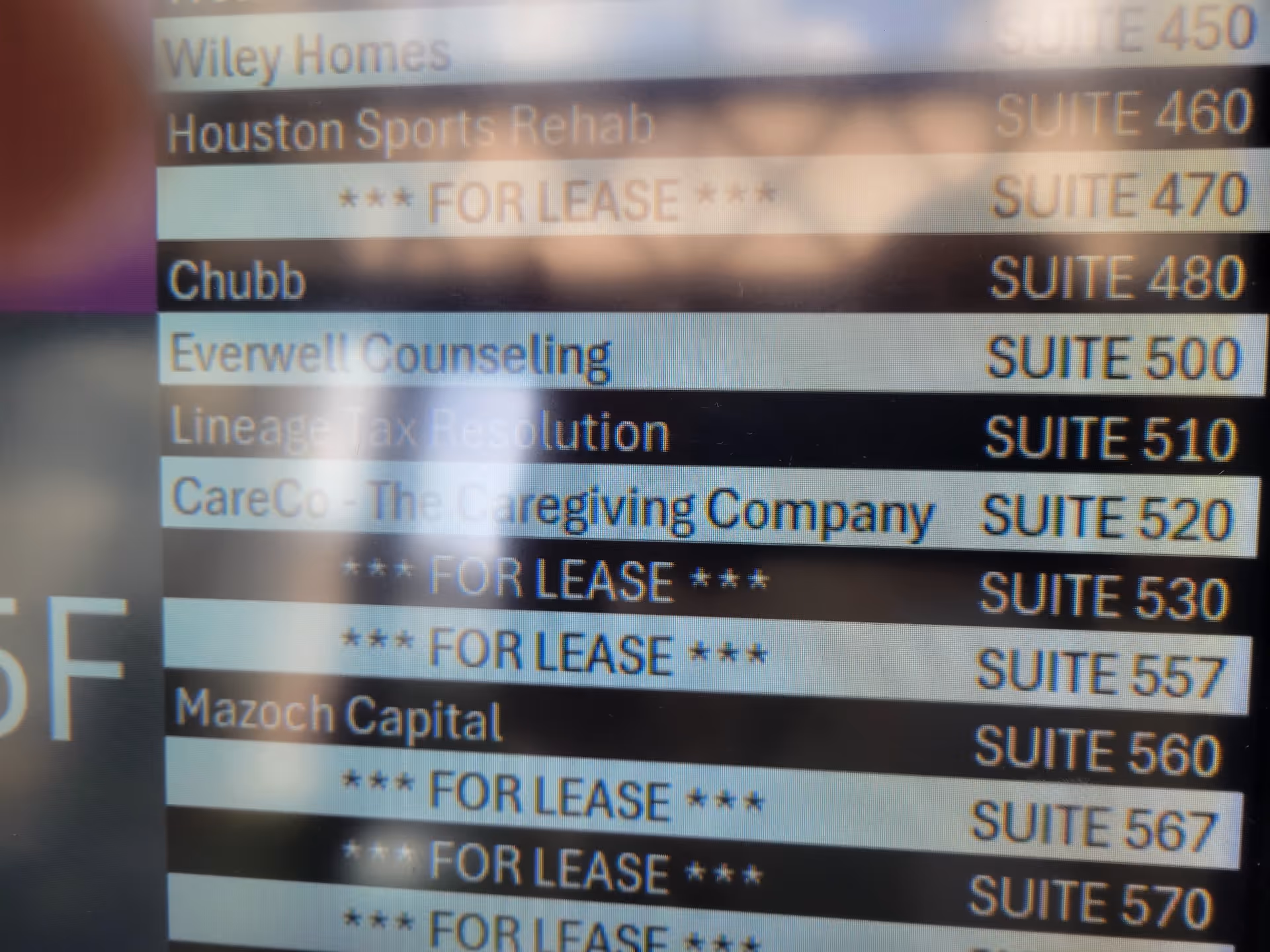 Interior building directory listing multiple suites, including CareCo The Caregiving Company
