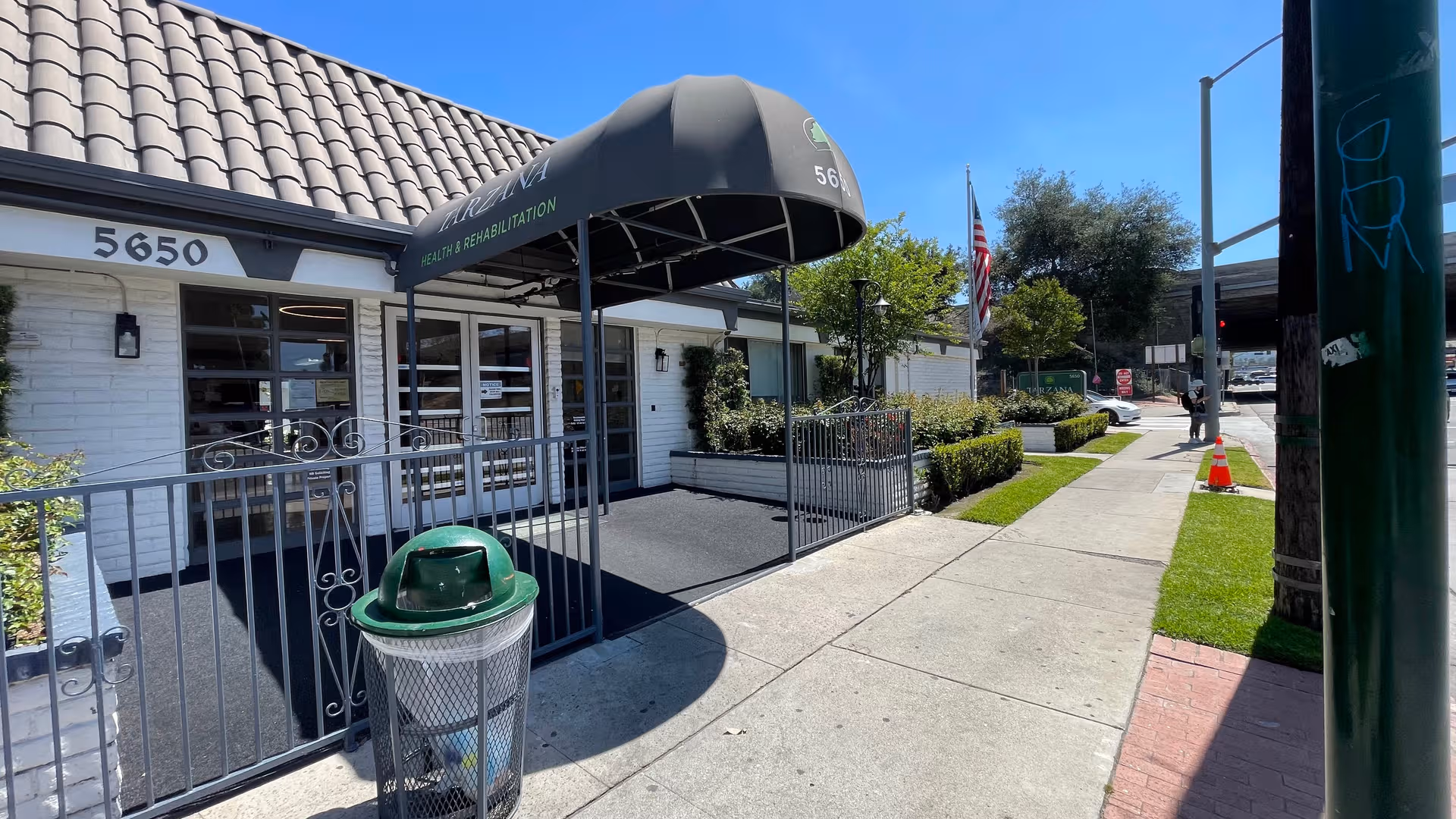 Exterior view of Tarzana Health and Rehabilitation Center entrance with awning and sidewalk.