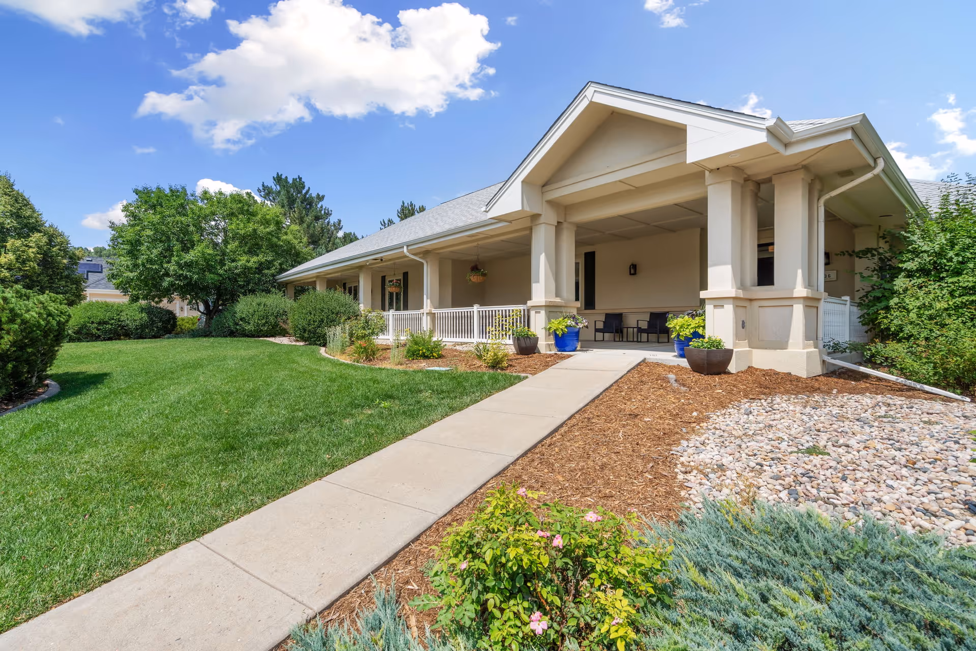 Miramont Memory Care exterior: single-story building with front porch and landscaped yard.