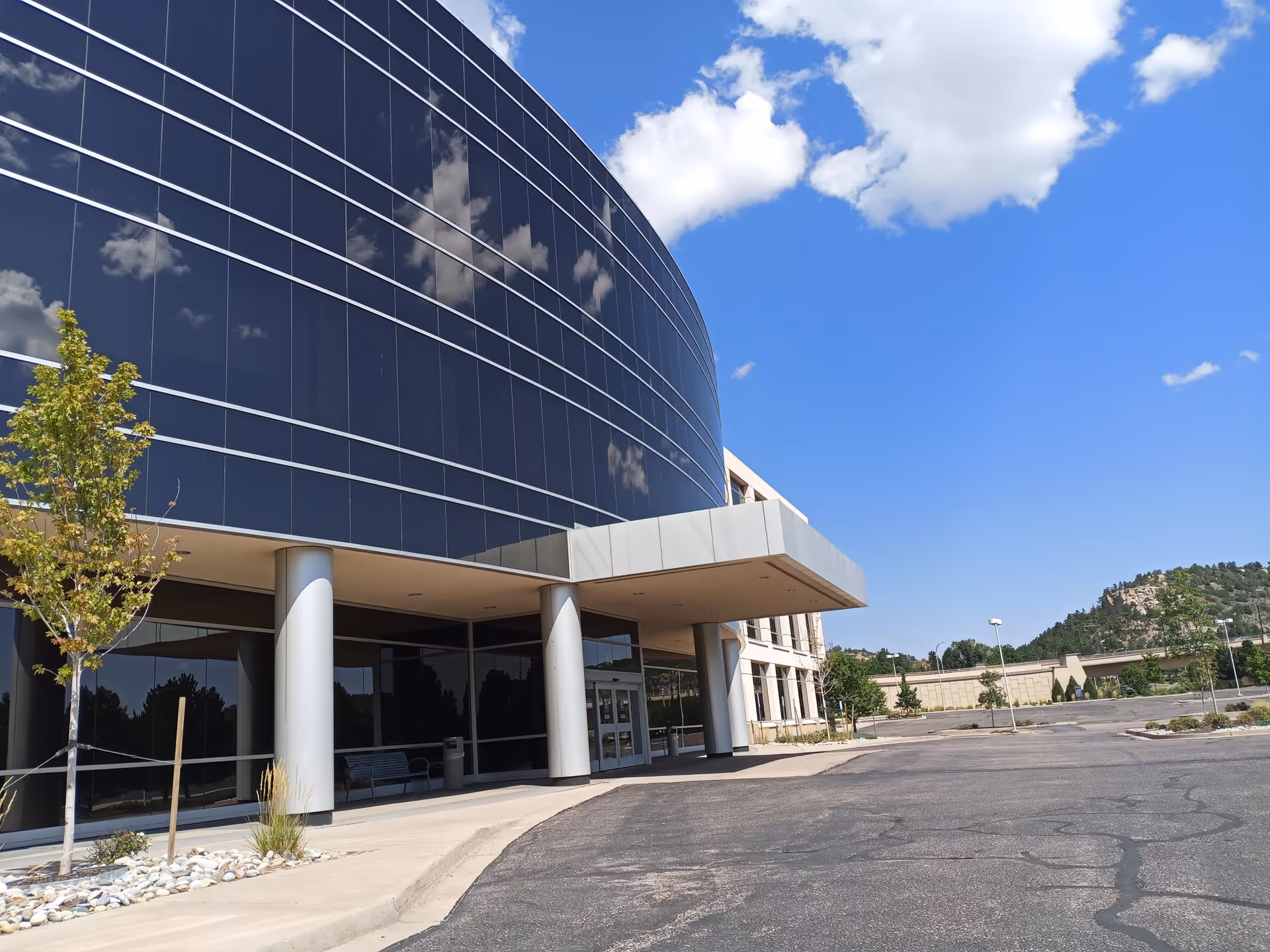 Premier Surgery Center building exterior with curved glass facade and entry under a canopy.