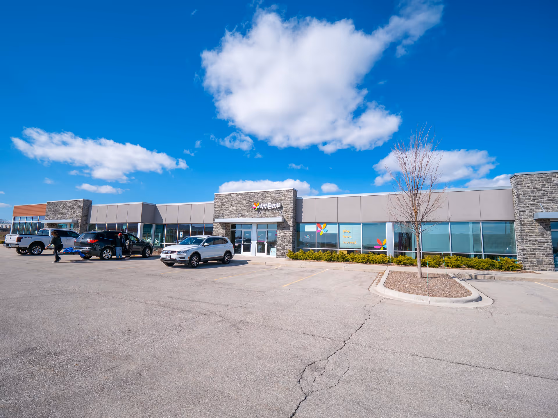Exterior view of a Total Spectrum ABA building with parking lot and blue sky.
