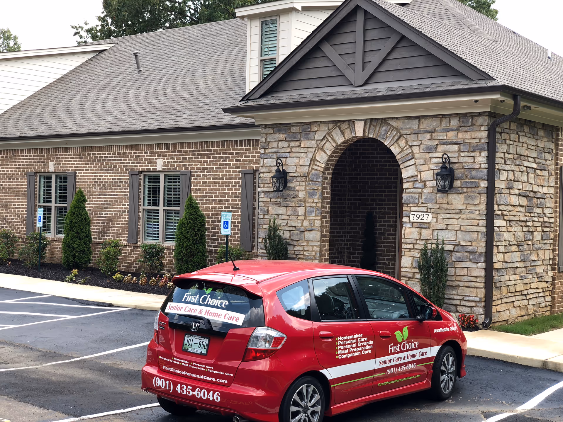Exterior view of a senior care facility with a red First Choice vehicle.