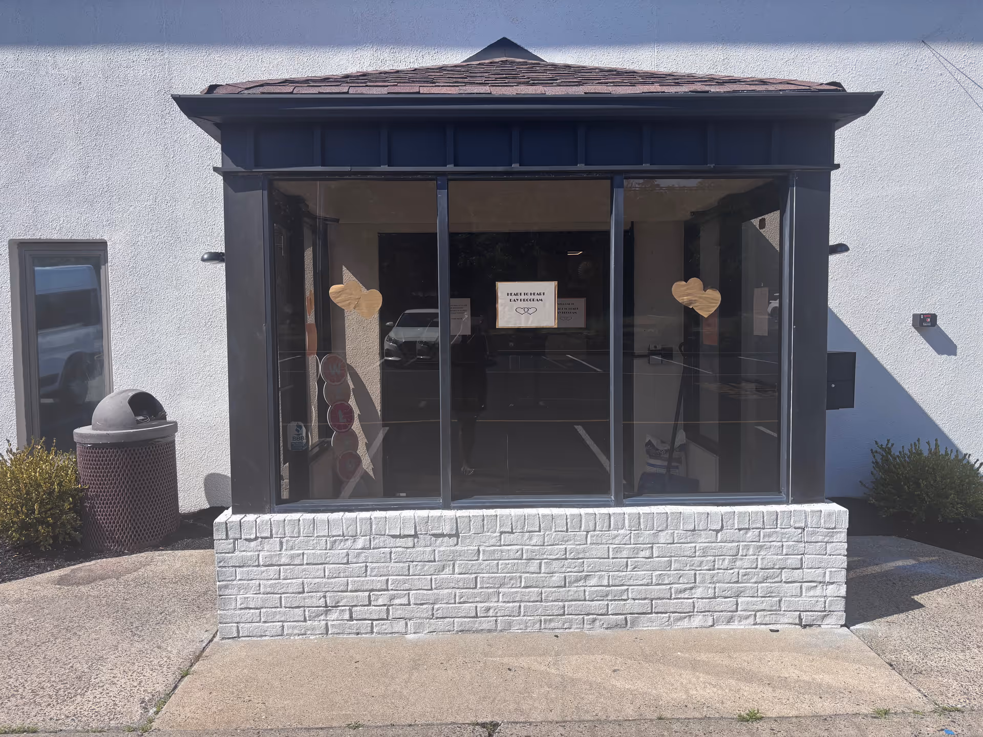 Front entrance of Heart to Heart Adult Day Program with glass doors and hearts