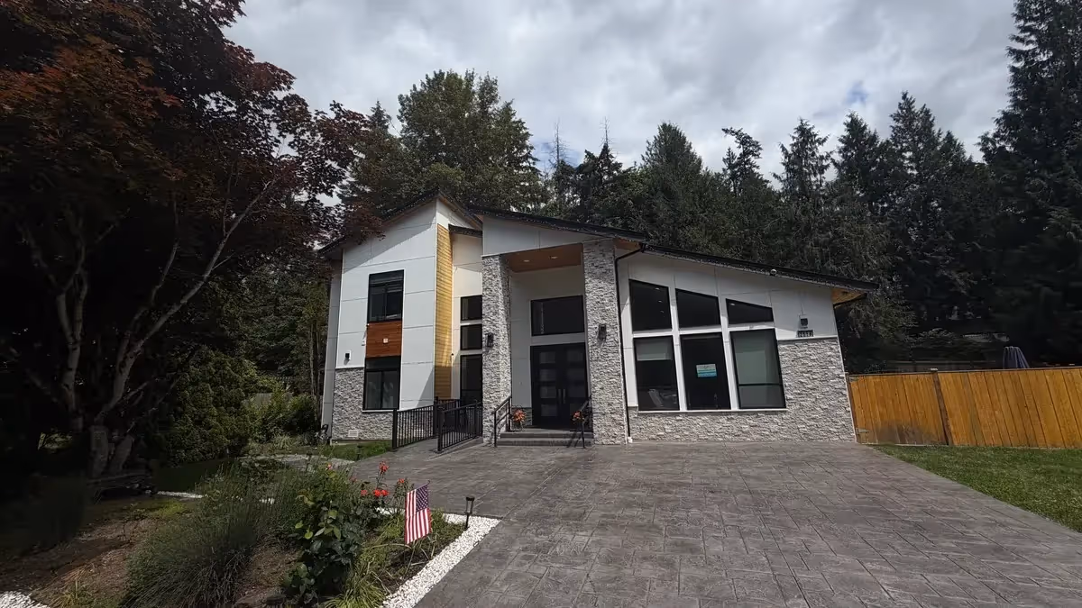 Modern single-story senior living facility exterior with stone accents and large windows.