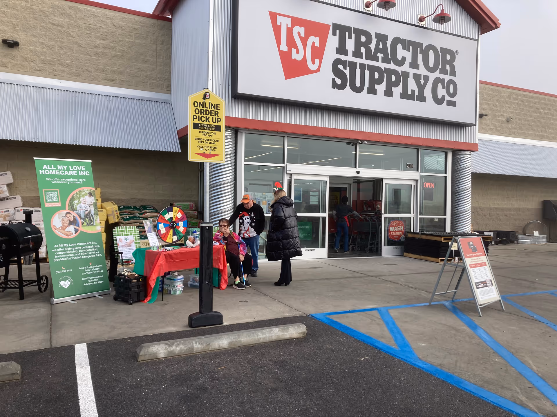 Front of Tractor Supply Co store with All My Love Homecare banner and outdoor booth.