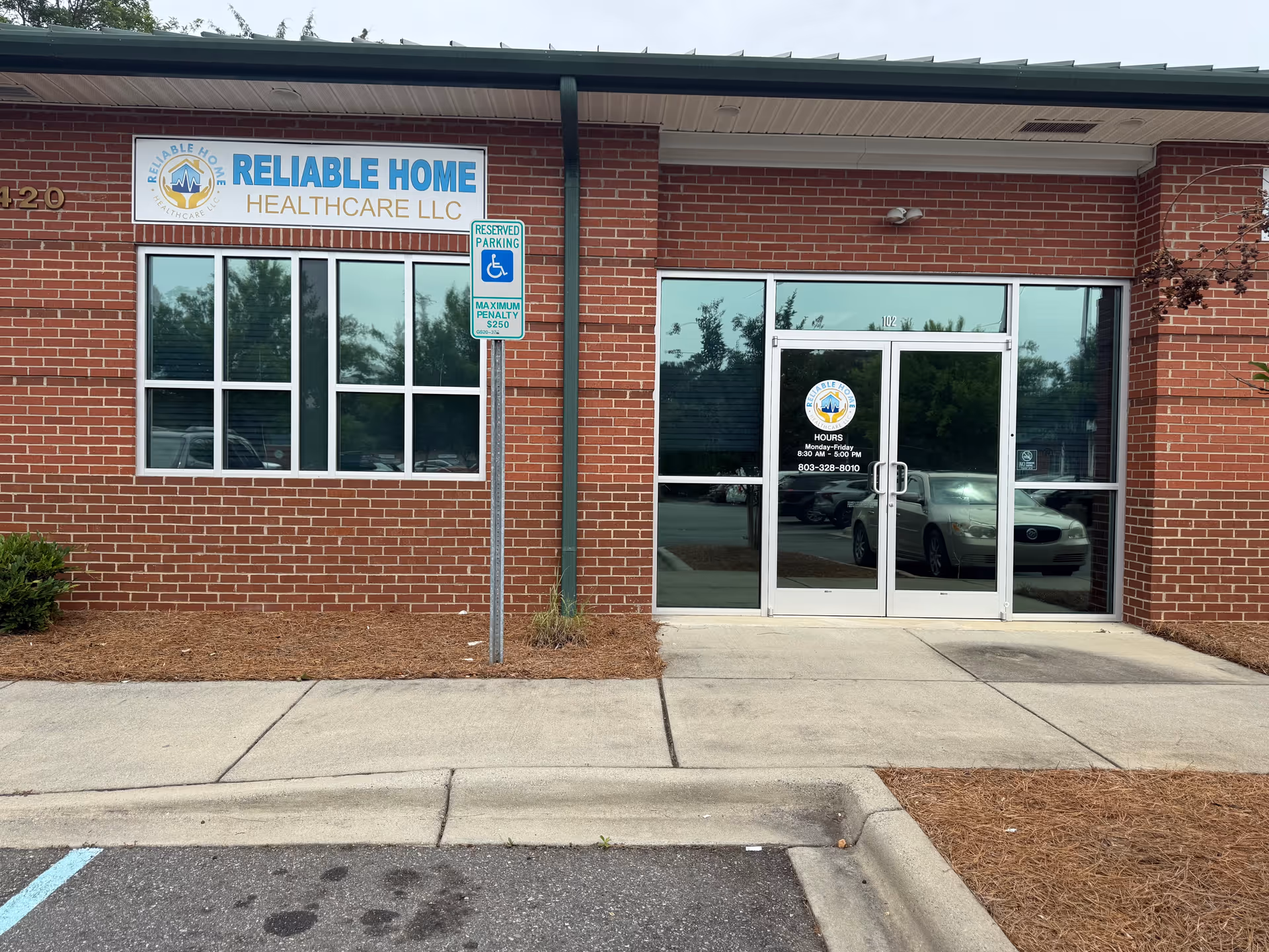 Brick storefront with glass doors and Reliable Home Healthcare LLC signage.