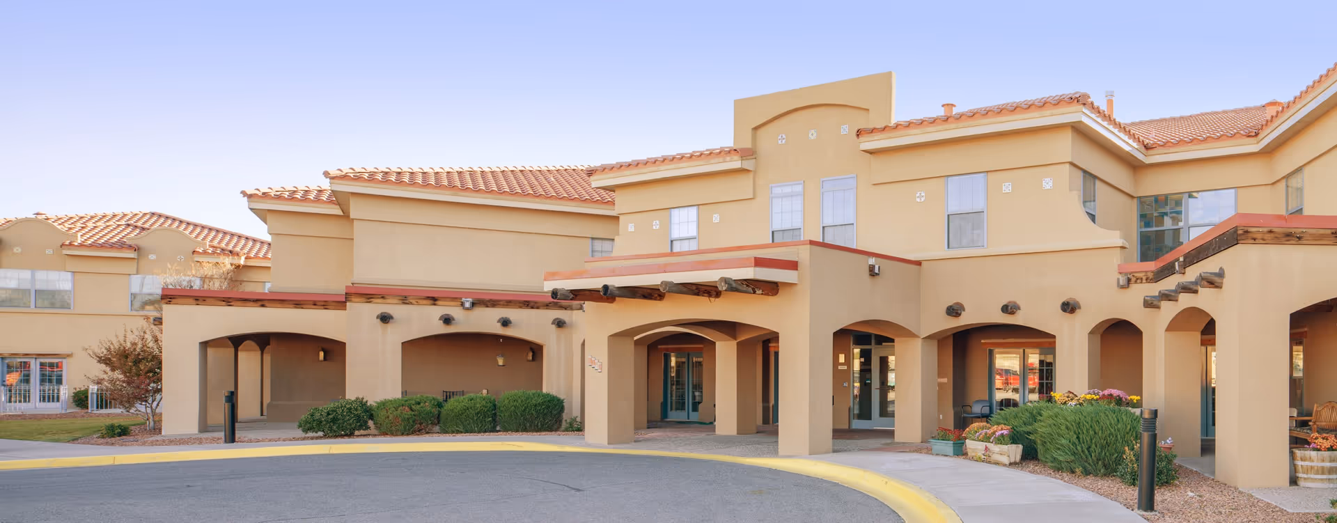 Front exterior of The Village at Northrise - Morningside building with arched entryways.
