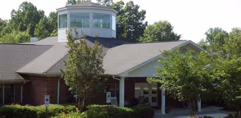 Southfork senior living facility exterior with brick entrance and trees