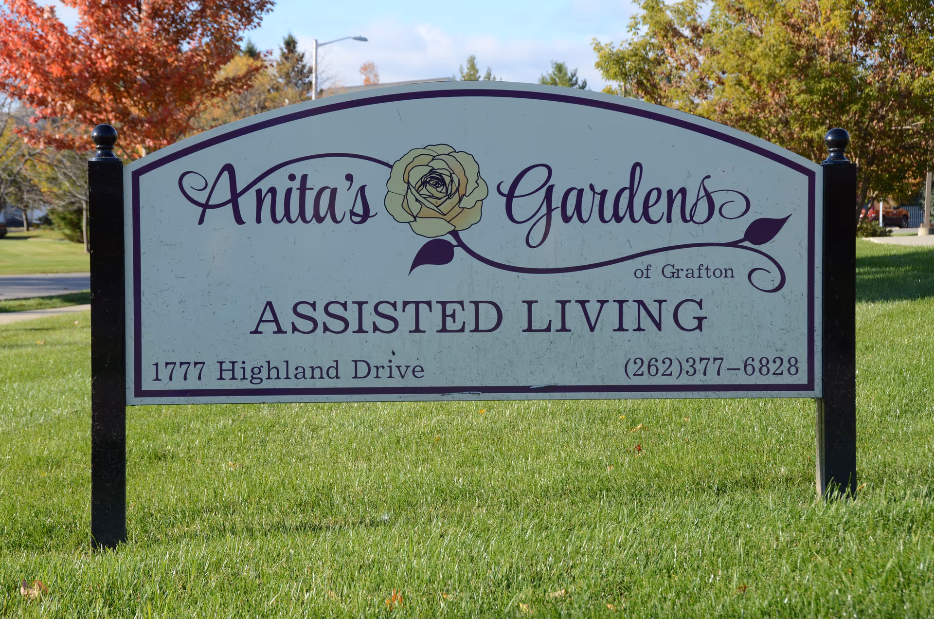 A large sign on a grassy lawn for Anita's Gardens of Grafton Assisted Living.