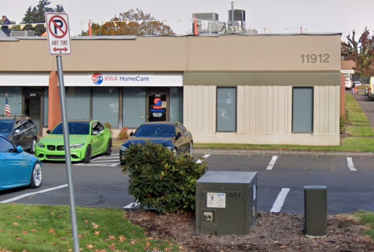 Front exterior of KWA HomeCare building in Vancouver, WA with parked cars.