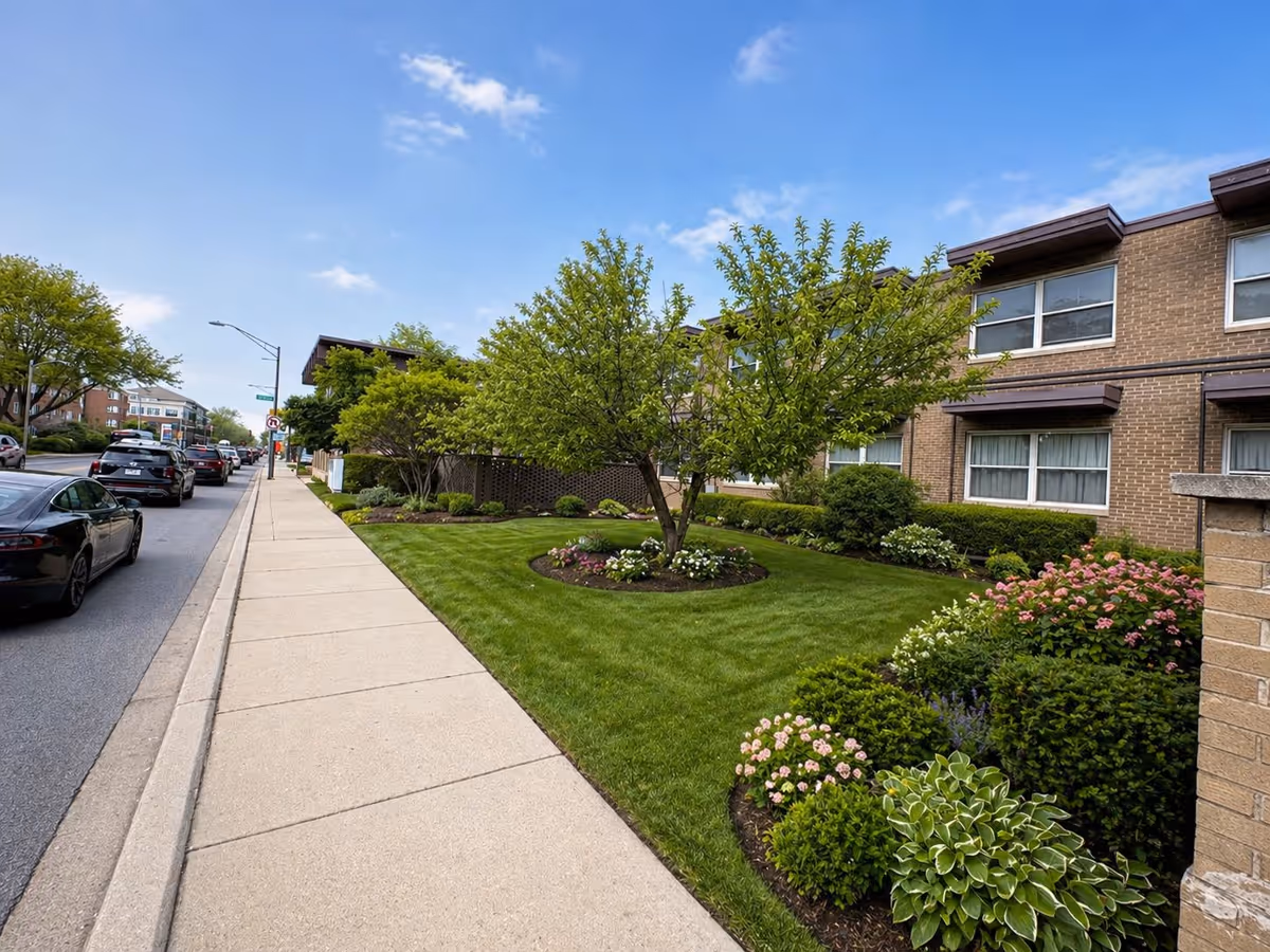Exterior view of Oak Park Oasis with brick building, sidewalk, and landscaped lawn.