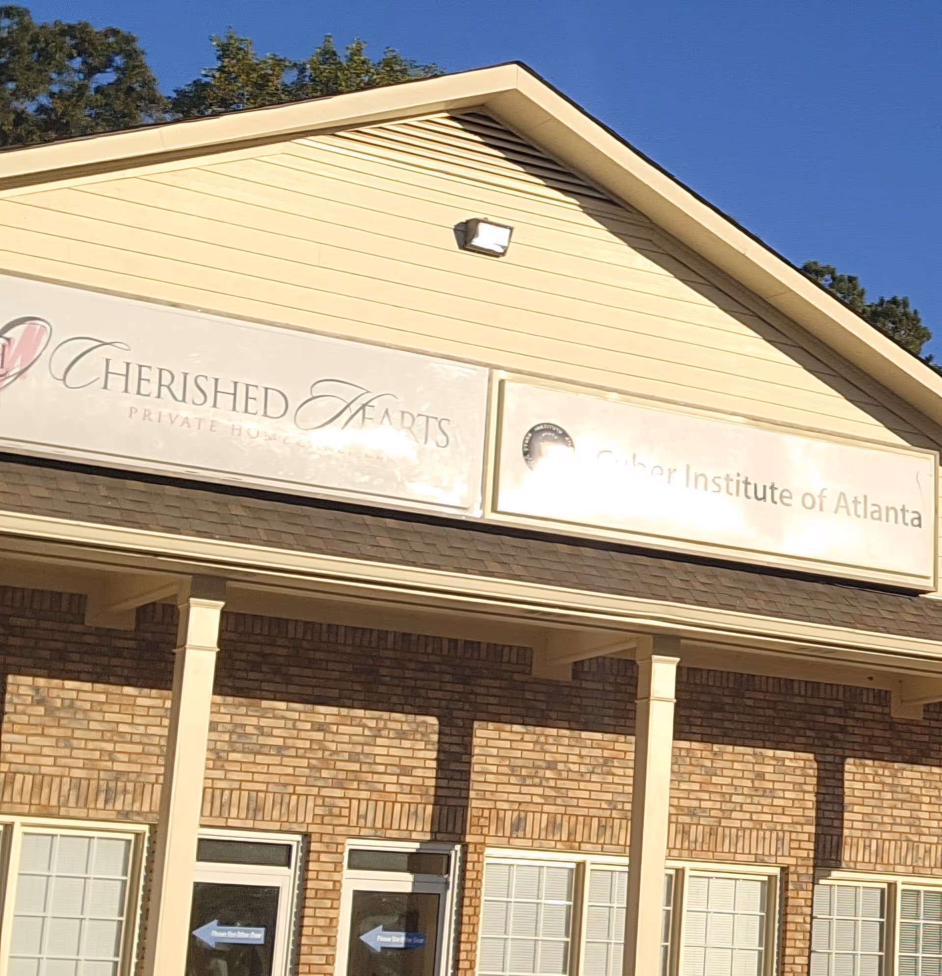 Front view of a brick facility with Cherished Hearts signage