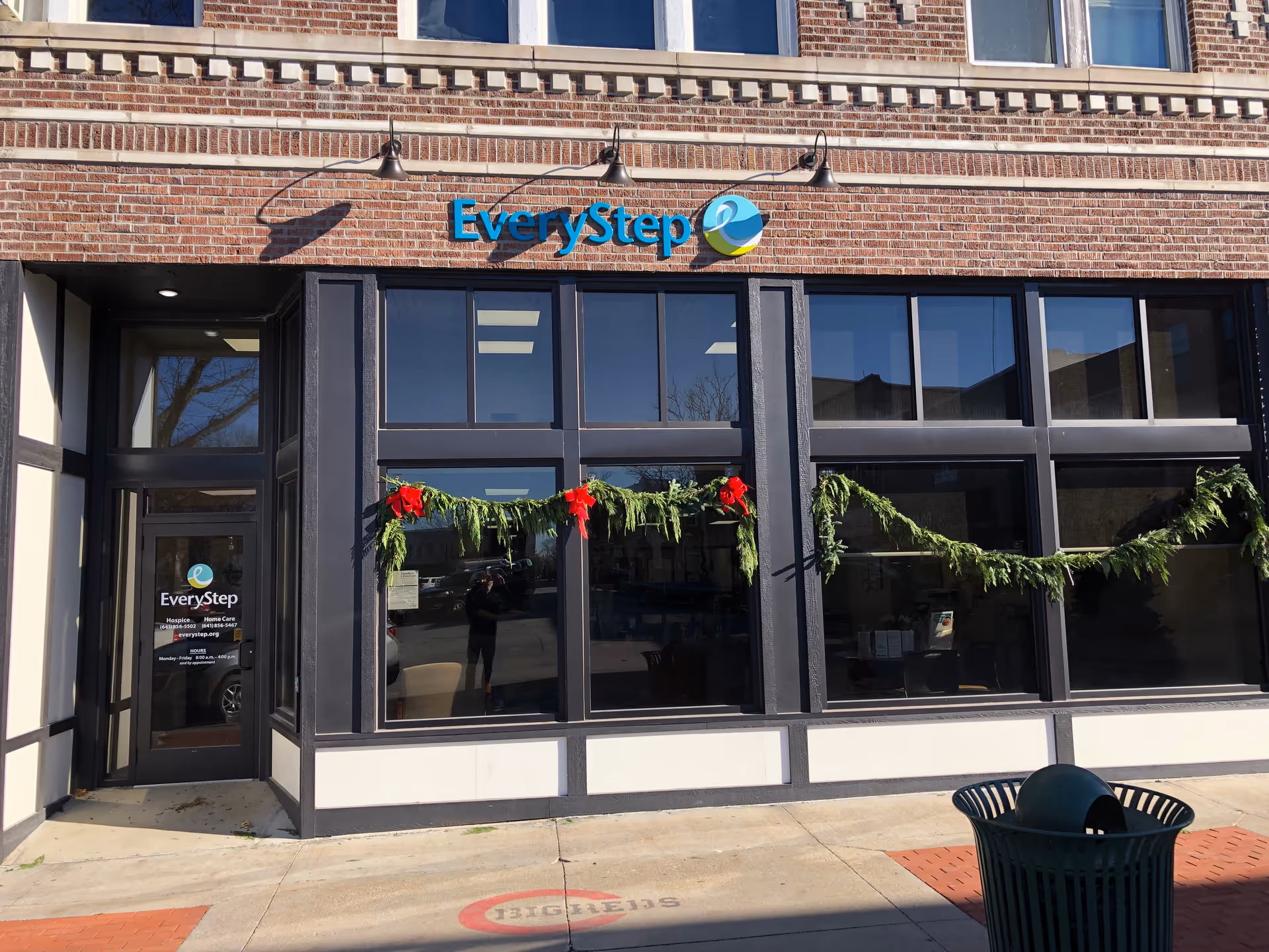 Front of EveryStep building with brick facade, large windows, and garland.
