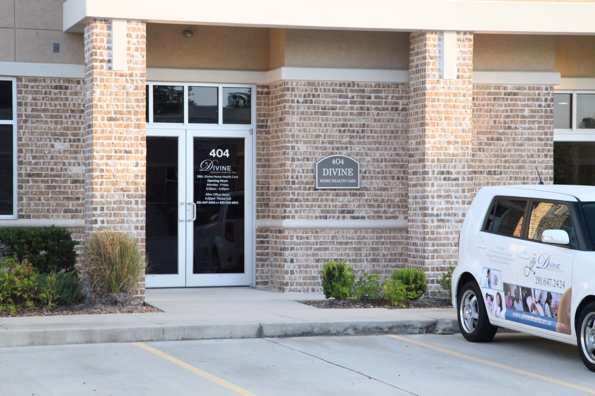 Exterior brick building entrance labeled Divine Home Health Care with a branded van nearby.