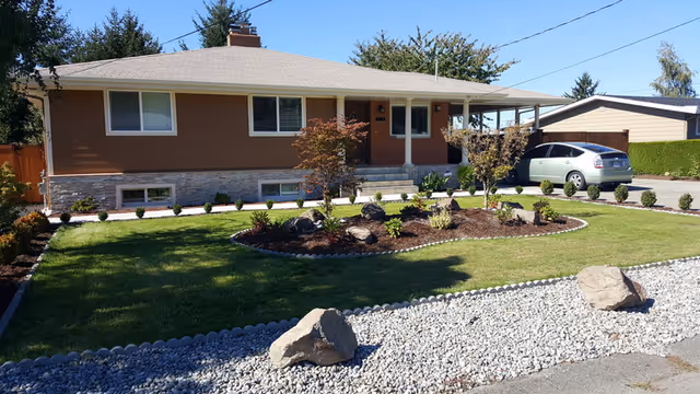 Front view of a Sunset Home Care facility, a single-story house with a landscaped lawn.