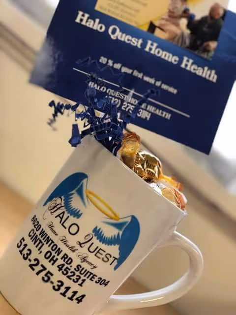 Halo Quest Home Health mug filled with candy sits on a desk with brochure in background.