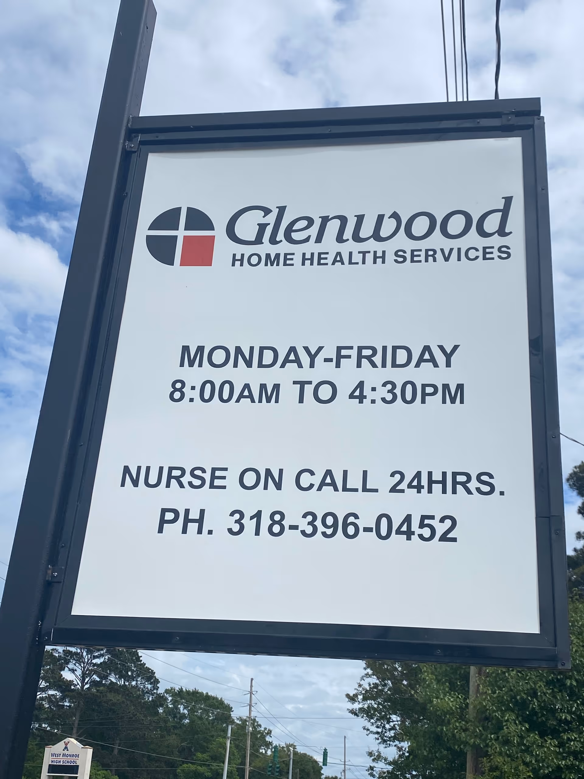 Outdoor sign for Glenwood Home Health Services showing hours and phone number.