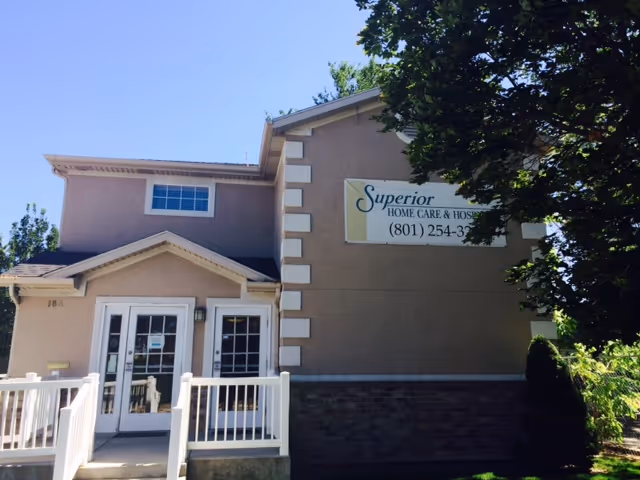 Exterior view of a beige senior care facility with a Superior Home Care & Hospice sign.