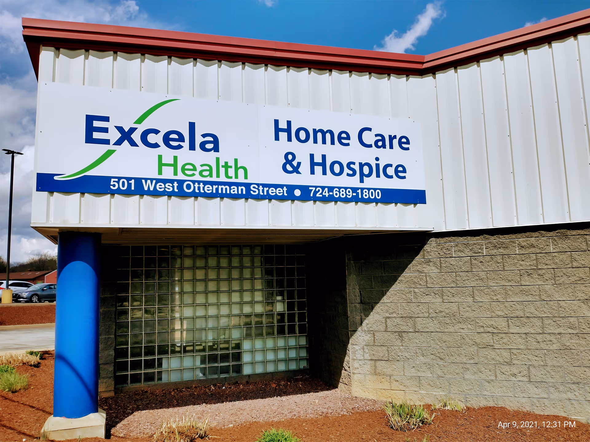 Exterior view of Excela Health Home Care & Hospice sign on a building facade.