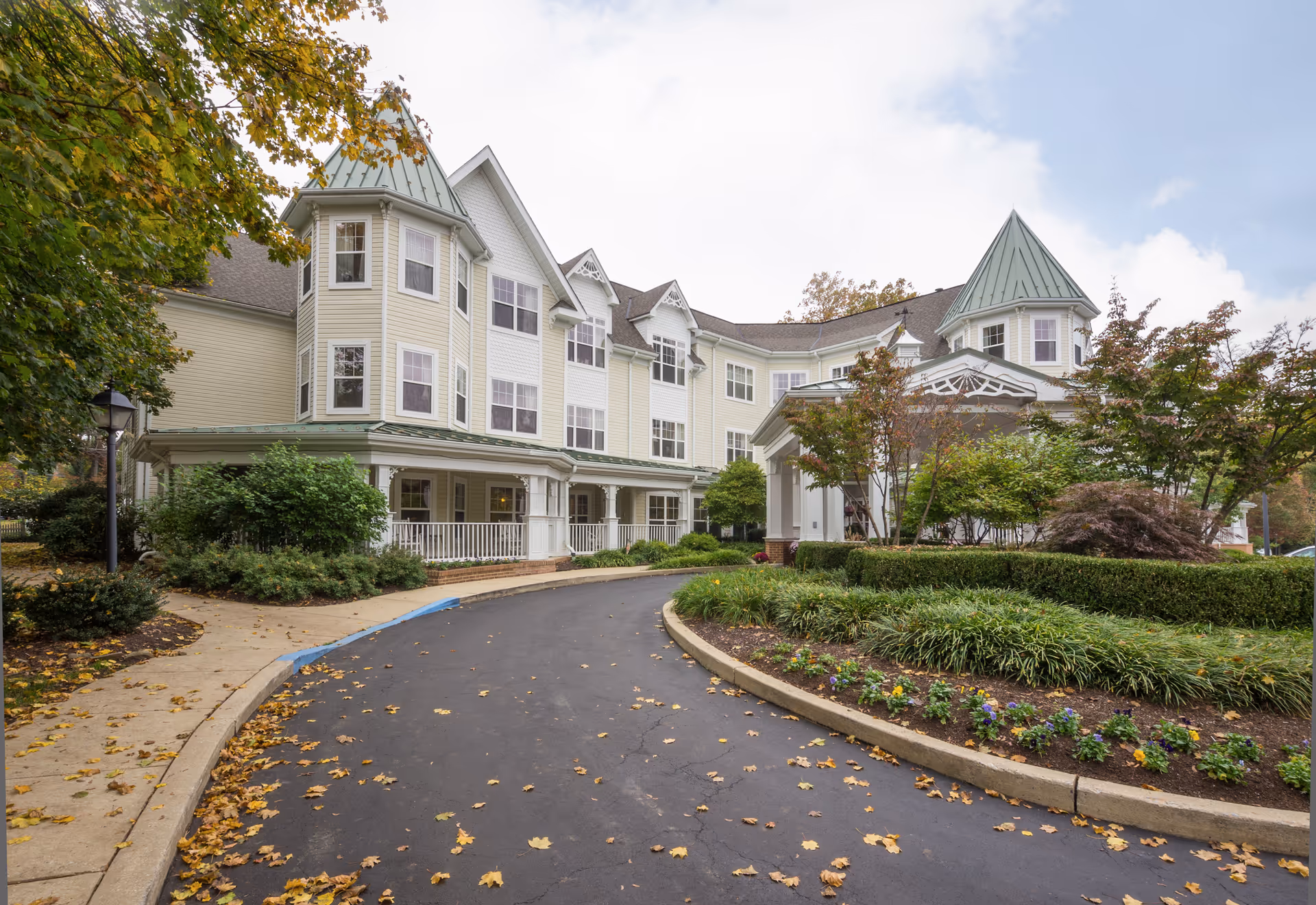 Exterior view of Sunrise of Haverford, a multi-story senior living facility with a landscaped entry.