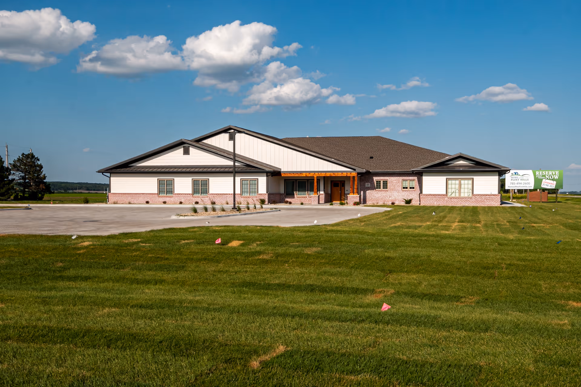 Front exterior of Home of the Flint Hills, a single-story senior living facility with brick accents.