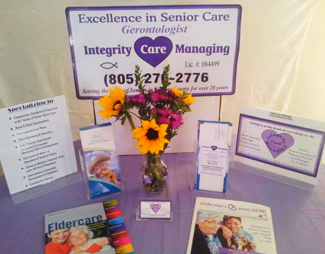 Interior display table with brochures, a vase of flowers, and care signage for Integrity Care.