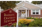Front view of Daggett-Crandall-Newcomb Home with sign and stairs.