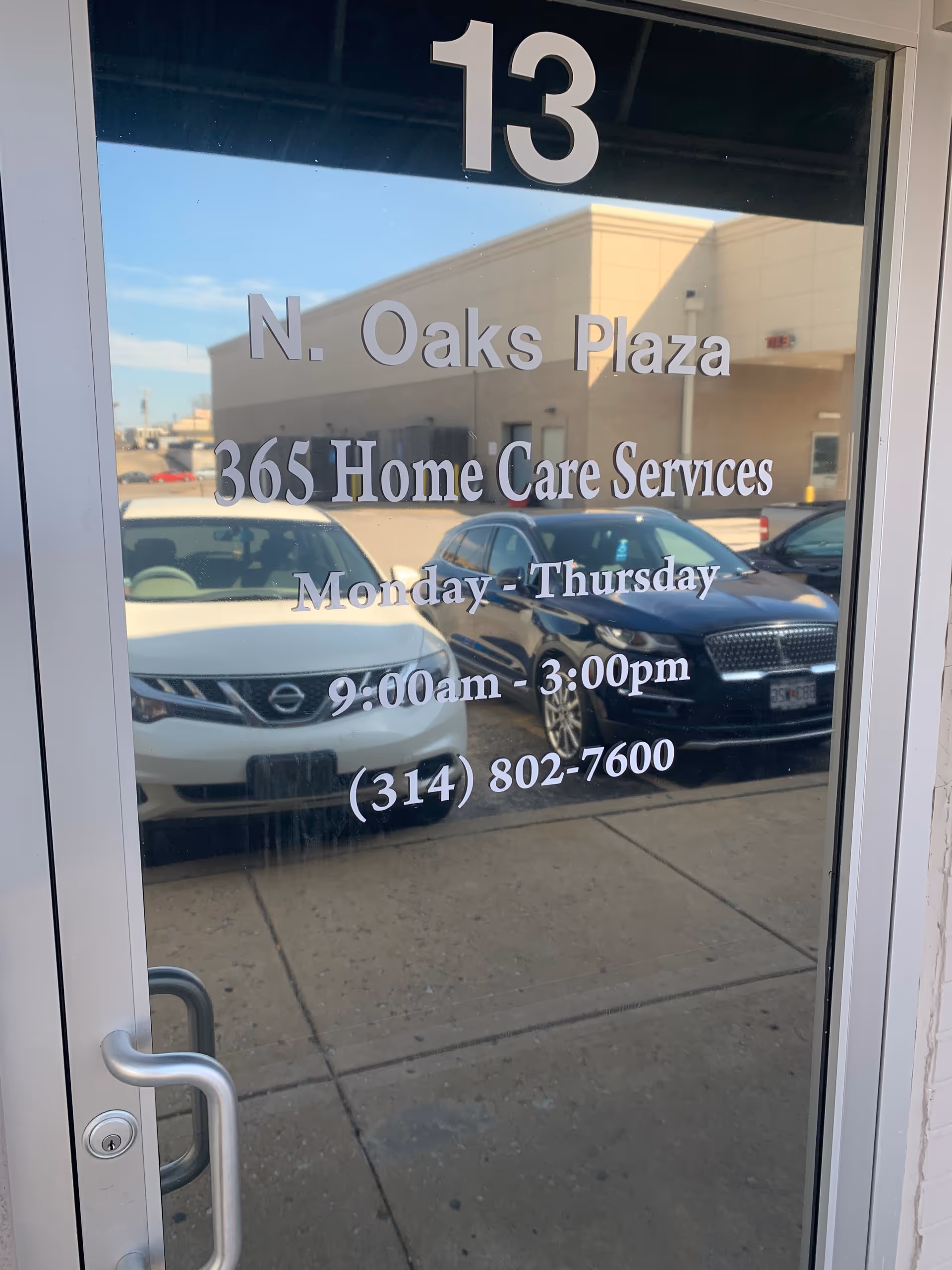 Glass entry door displays address and hours for 365 Home Care Services at N. Oaks Plaza.