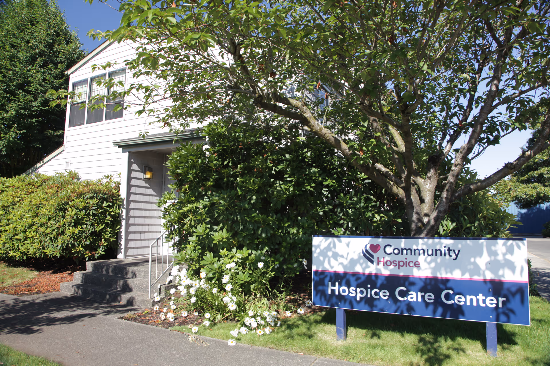 Exterior view of a two-story building with a large Hospice Care Center sign.