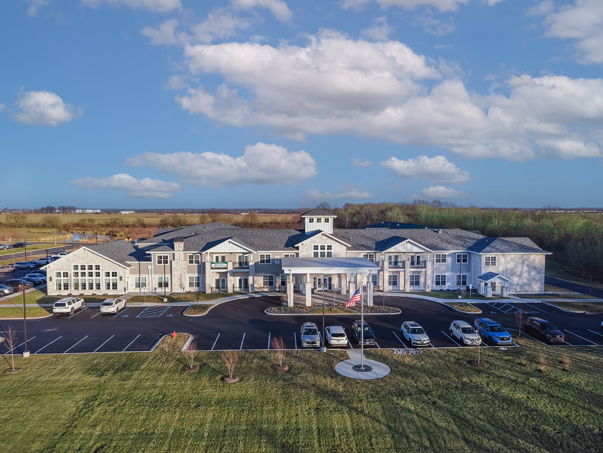 Aerial view of Cedarhurst Senior Living at Crown Point, showing front of the building and parking.