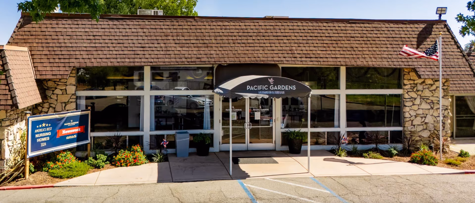 Front entrance of Pacific Gardens Nursing and Rehabilitation Center with glass doors