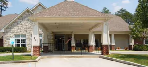 Front exterior of Brookdale Harbison Senior Living with a covered entrance and stone facade.