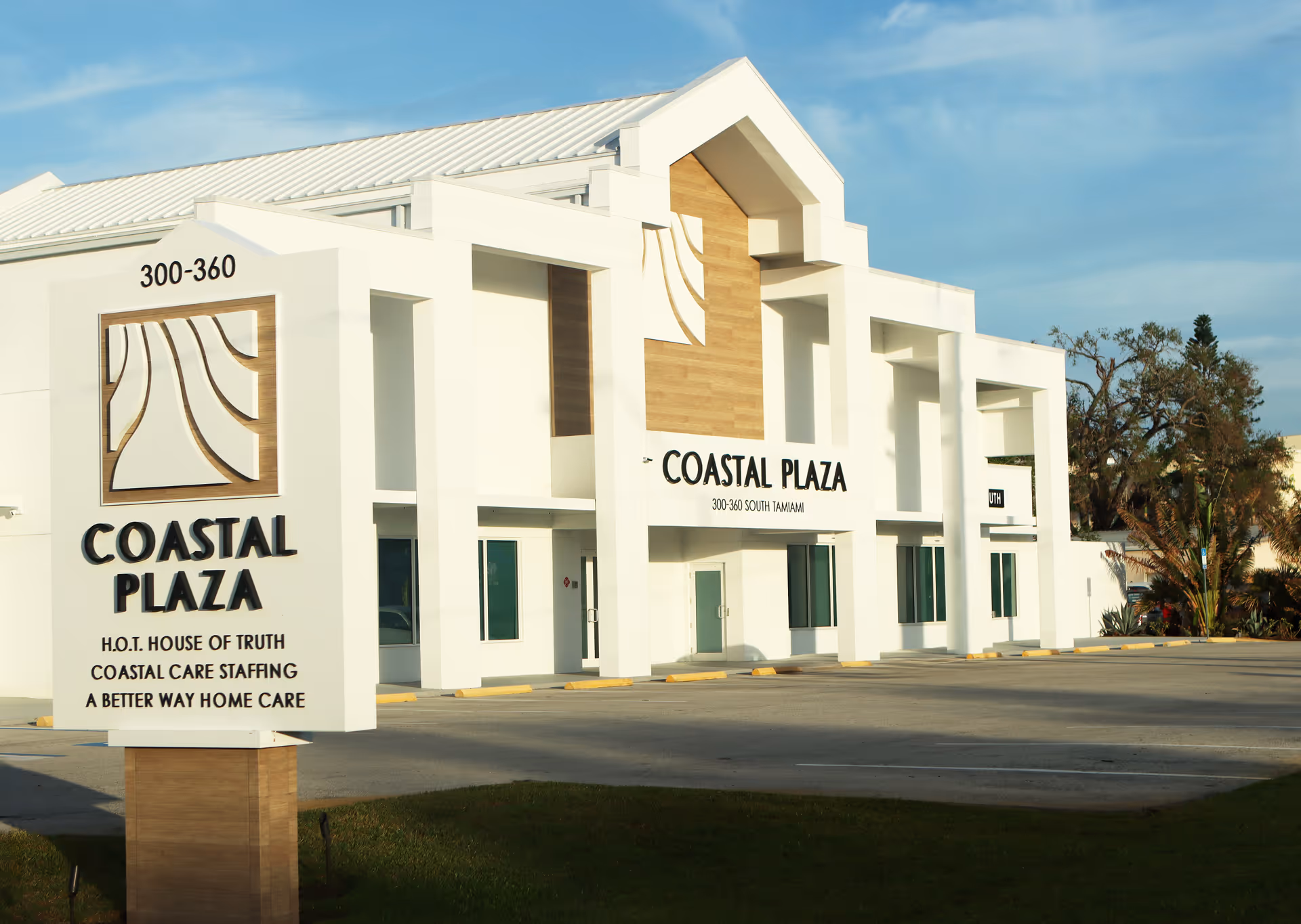Exterior view of a white building with Coastal Plaza signage and A Better Way Home Care.